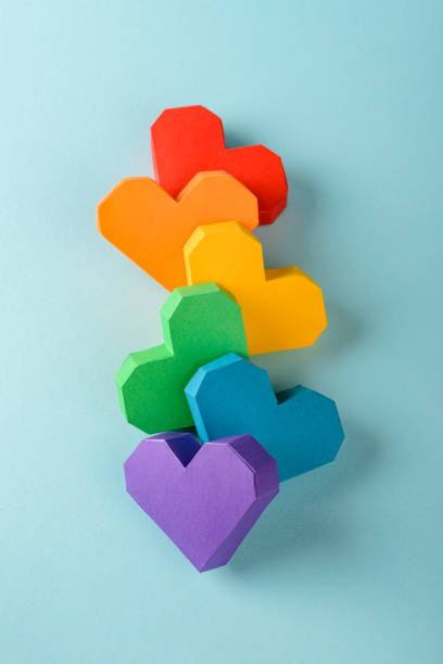 istock Beautiful composition of 3D paper hearts on blue background 1255628000