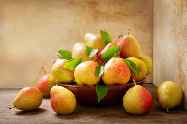 istock fresh pears in a bowl on a wooden table 1255628125