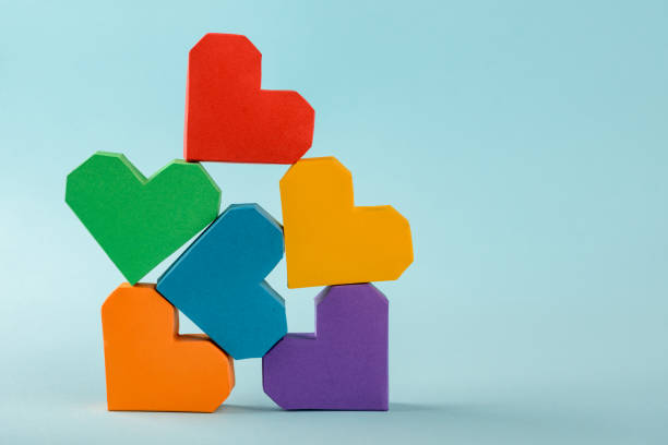 istock Stack of 3d paper hearts on blue background 1255628202