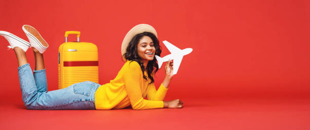 istock Ethnic traveler playing with toy plane 1255635807