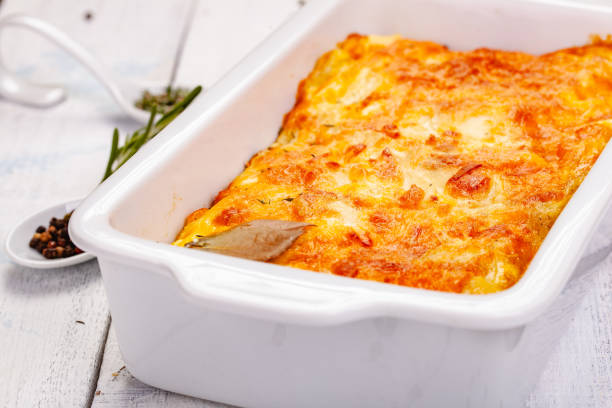istock Potato gratin in white casserole dish on wooden rustic table. Close up 1255644754