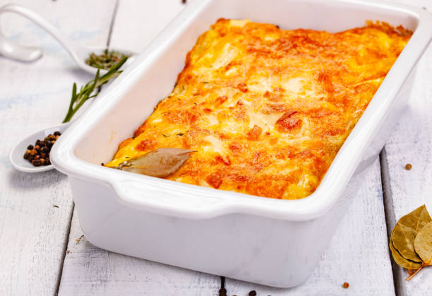 istock Potato gratin in white casserole dish on wooden rustic table. Close up 1255644761