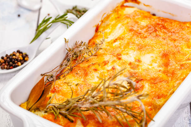 istock Potato gratin in white casserole dish on wooden rustic table. Close up 1255644768