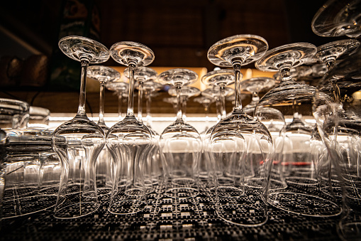 Close up of washed empty wineglasses on the bar, turned upside down