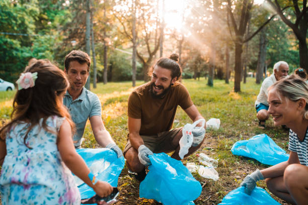 istock Group of environmentalists teaching their kids to keep the environment clean 1255650907