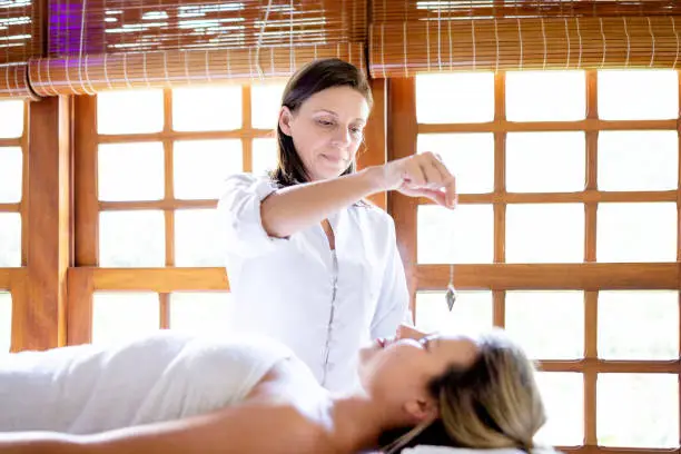 Therapist using pendulum