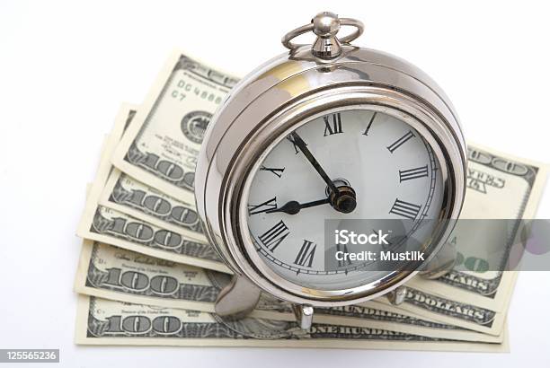 Dinero Y Reloj Foto de stock y más banco de imágenes de Acurrucado - Acurrucado, Ahorros, Billete de banco