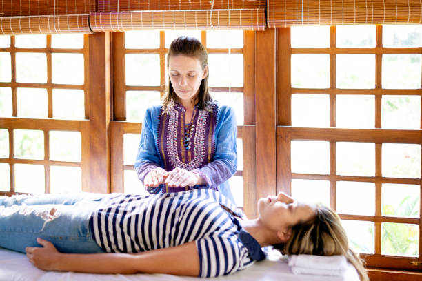 istock Therapist applying Reiki in a patient 1255652418