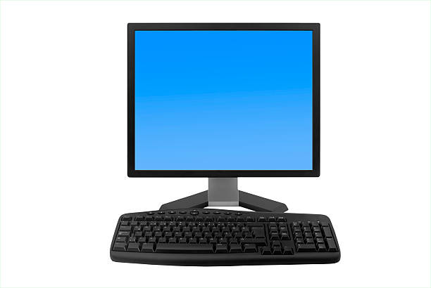 Old computer monitor on a wooden table in front of a wall with scuffed plaster