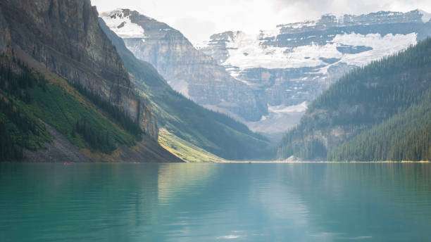 istock Beautiful turquoise glacial lake with mountains in backdrop 1255657091
