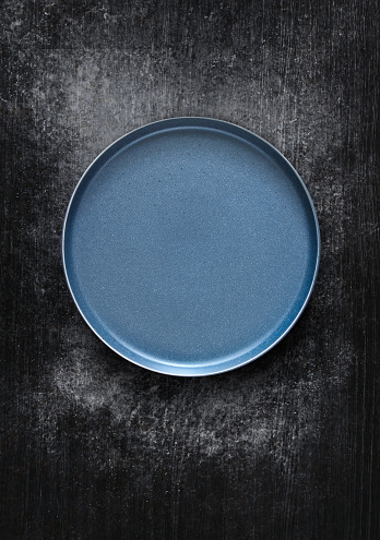 Empty blue plate on black background