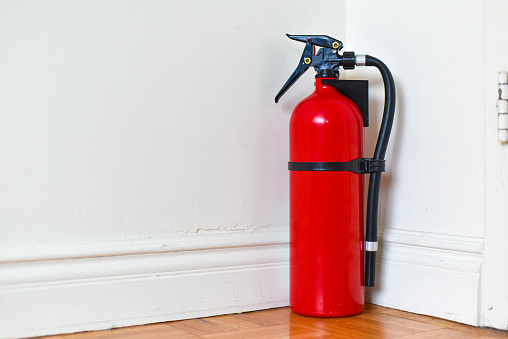 A fire extinguisher against a wall