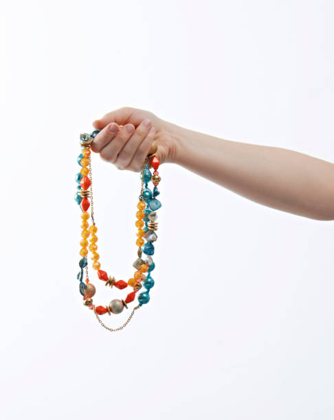 istock Woman holding a necklace 1255661240