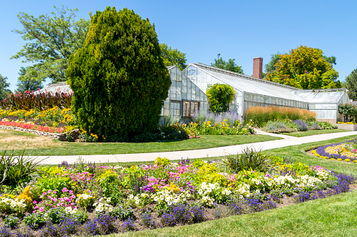 July 11, 2020 - Salt Lake City, Utah, USA: This shot shows the beautiful landscaping that is part of Liberty Park in Salt Lake.  The flowers for the display were grown in the greenhouses in the background.