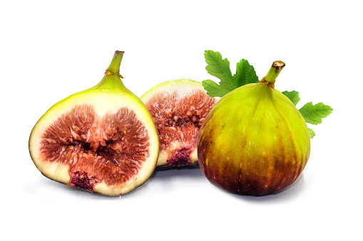 Fresh Brown turkey figs with leaves isolated on white background.