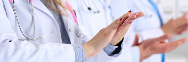 istock Group of doctors clapping their hands during medical conference 1255671966