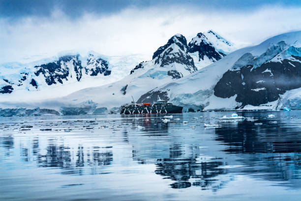 Cruise Ship Blue Glacier Snow Mountains Paradise Bay Skintorp Cove Antarctica Cruise Ship Blue Glacier Snow Mountains Paradise Bay Skintorp Cove Antarctica. Glacier ice blue because air squeezed out of snow. paradise bay antarctica stock pictures, royalty-free photos & images