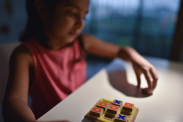 Girl playing Tic-tac-toe under trample lamp