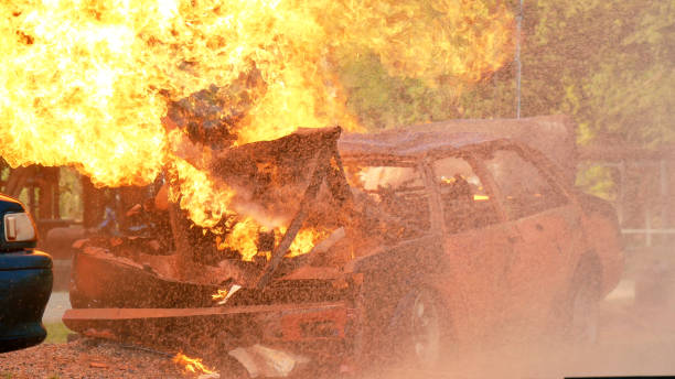 istock Firefighter fighting with flame using fire hose chemical water foam spray engine. Fireman wear hard hat, body safe suit uniform for protection. Rescue training in fire fighting extinguisher 1255677569