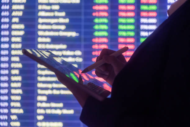 istock Woman looking stock market Data on smart phone 1255683022