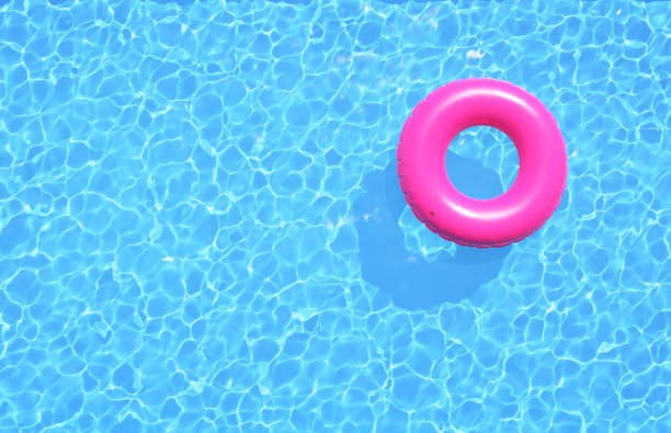 clear water in swimming pool with pink swimming ring. top view, 3d illustration - float around imagens e fotografias de stock