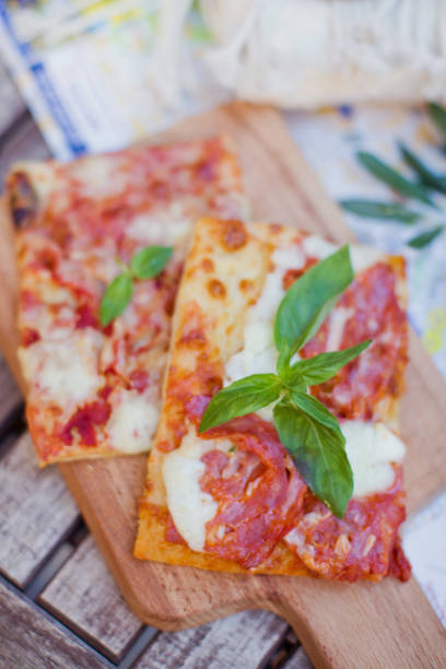 istock Slices of pizza with basil 1255684062