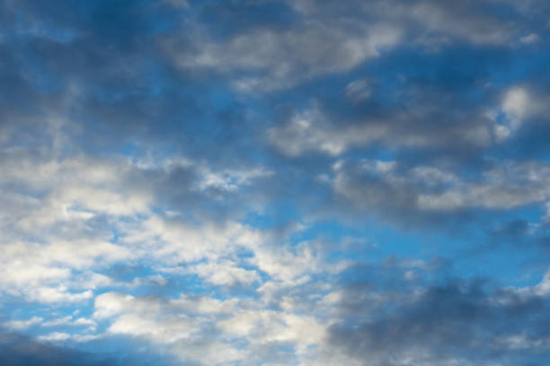 istock Beautiful clouds with blue sky background. Nature weather, cloud blue sky and sun. A rays of sunlight breaking through dark clouds. 1255685117