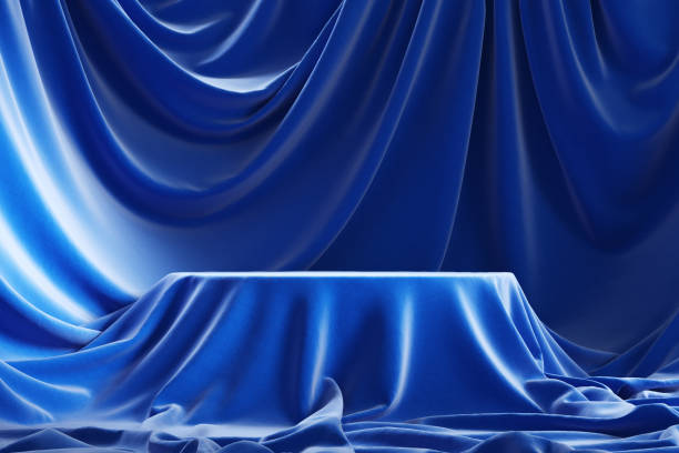 istock Empty podium covered with blue cloth. Interior hidden under satin veil. 3d illustration 1255689639