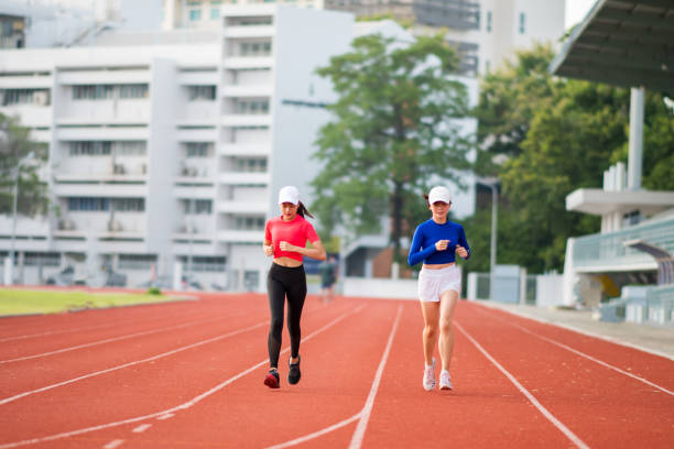 istock Asian women practicing walking and running on the running track. 1255689640