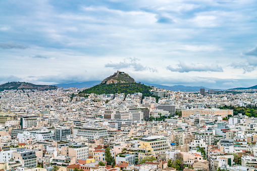 View of Lycabettus mount from Acropolis hill in Athens, Greece. Cityscape of historical town of Athens with old and modern Greek houses.