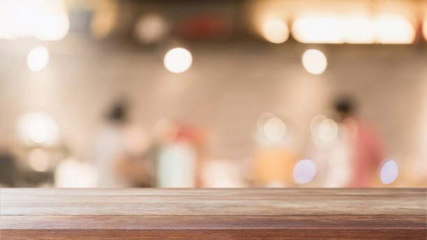 istock Empty wood table top and blurred coffee shop and restaurant interior background - can used for display or montage your products. 1255692324