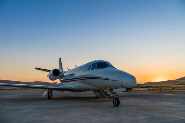 istock Business Jet on Ramp with Sun in Background 1255692805