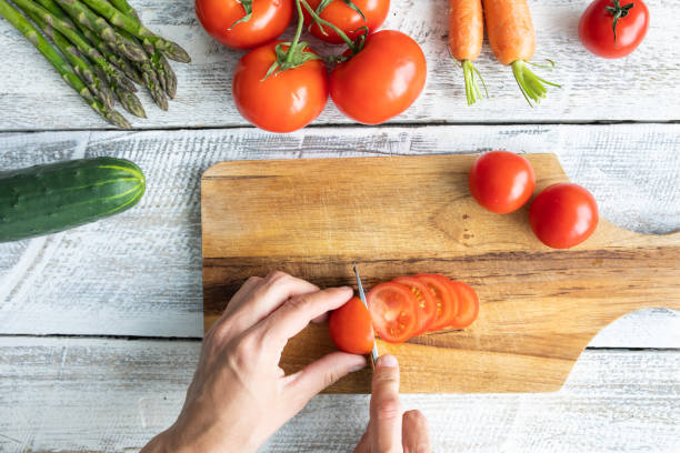 istock Fresh tomatoes with green leaves 1255693566