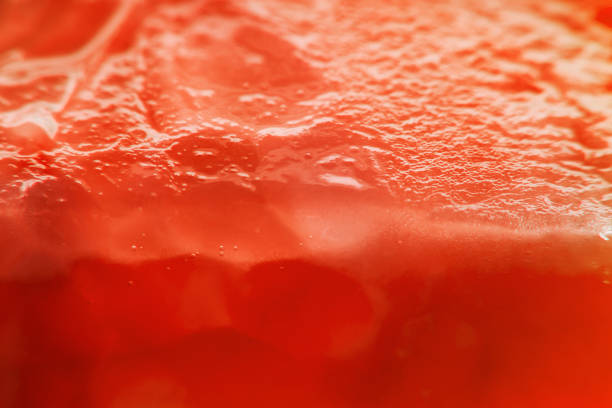 istock Background with sliced tomato under strong magnification in soft focus. A detailed image of the pulp of a ripe tomato. 1255695513