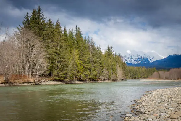 Photo of A deep green pool on a mountain river in the spring, British Columbia