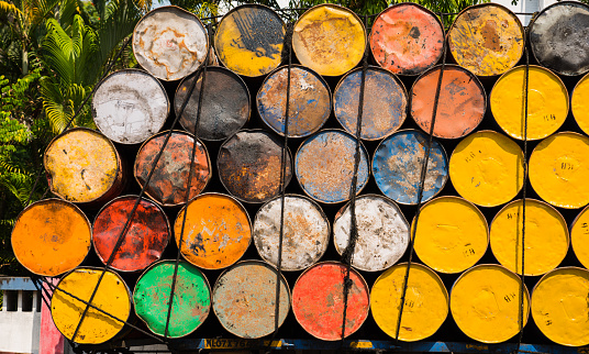 Truck loaded with empty yellow and colorful oil barrels in Kochi, South India