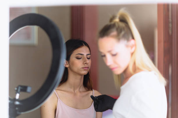 istock Makeup woman artist at work, professional in action, beauty salon and creative classes 1255704974