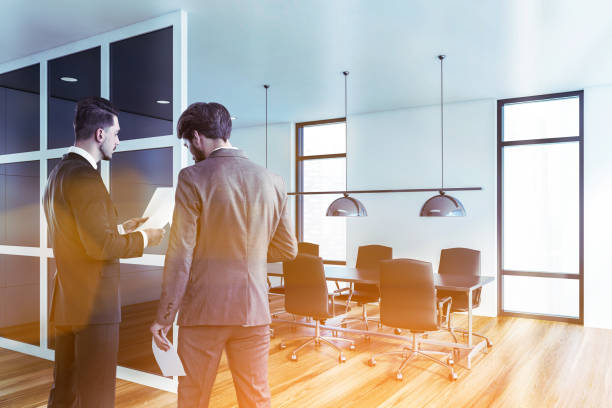 istock Managers talking in white and glass meeting room 1255706445