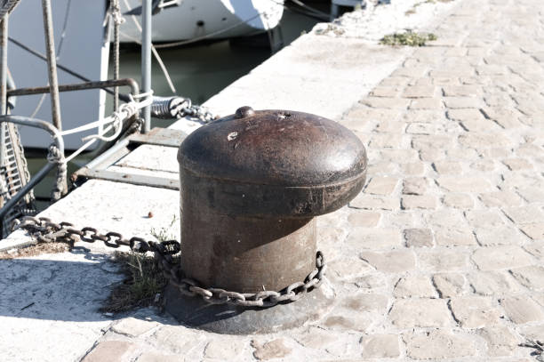 istock Rusty mooring bollard with an iron chain on the harbor pier (Pesaro, Italy, Europe) 1255707566