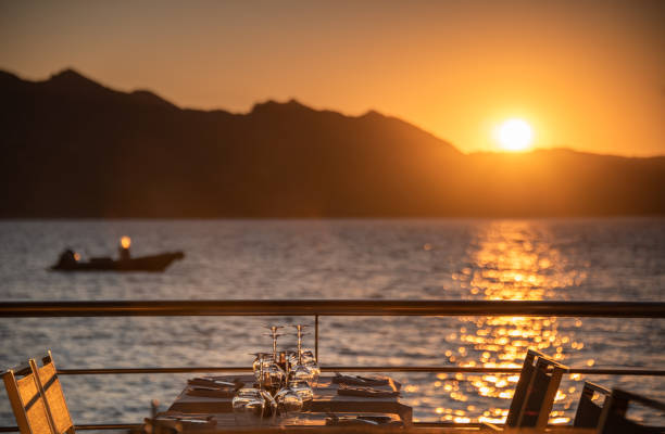 Romantic seafood restaurant Romantic restaurant setting, overlooking the Mediterranean sea at dusk corsica restaurant stock pictures, royalty-free photos & images