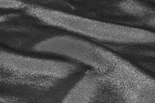 istock Black and white wavy silk fabric with folds. Mockup and blank designer for making a flag on a gray background. 1255708762