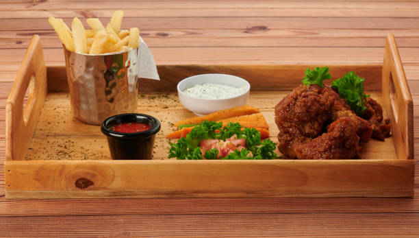 istock Wooden tray with fried chicken 1255710571