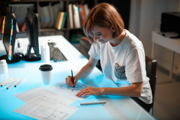 istock Young pretty creative woman designer is developing a new project, workspace in a creative company 1255710689