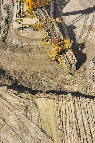 istock Huge bucket wheel excavator or mobile strip mining machine mining coal in a quarry. Heavy industry concept 1255710988