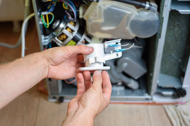 istock handyman repairs dishwasher. water leakage protection 1255713804
