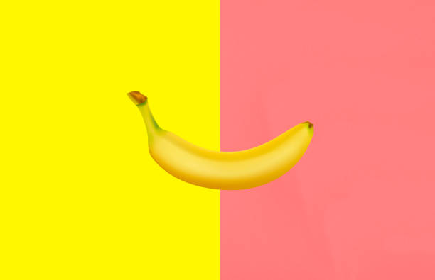 istock bananas isolated on yellow and pink background. 1255713871