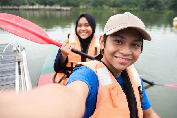 istock Young Asian siblings taking selfie on kayak at the lake 1255713921
