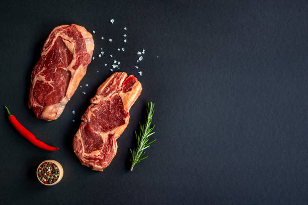 Two raw Rib eye Japanese steaks with spices