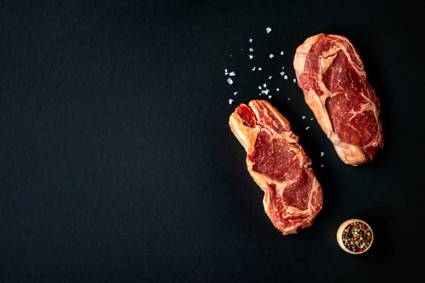 Two raw Rib eye Japanese steaks with spices