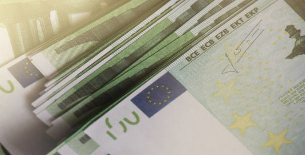 istock Many 100 Euro eurobancnotes bills. Selective focus. Money concept 1255717331